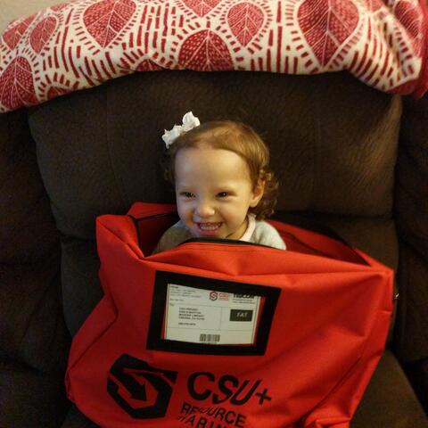 Child in a CSU-branded bag